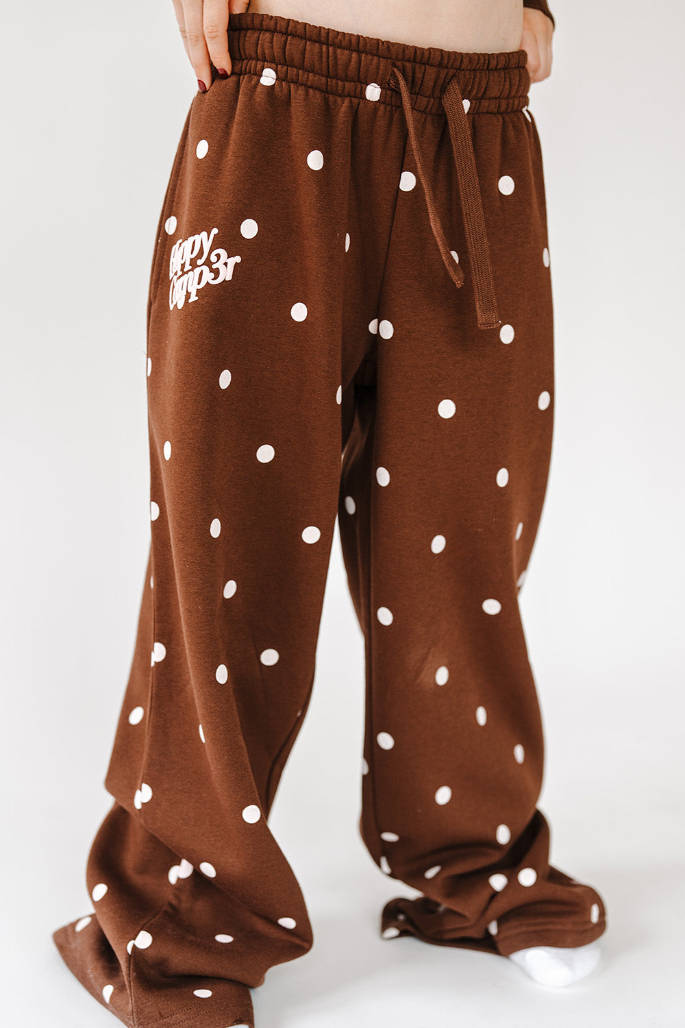 Cocoa Dot Youth Sweatpants in brown with pink polka dots, front view. The Happy Camp3r