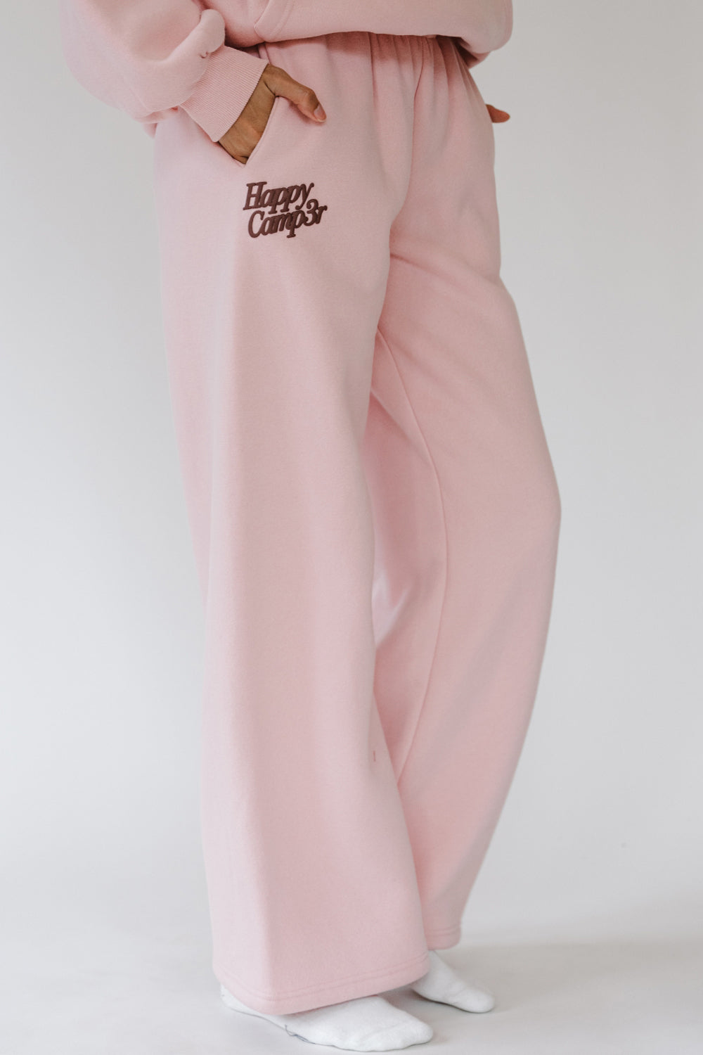 Light pink Puff Series Sweatpants with small Happy Camp3r logo, front view. The Happy Camp3r