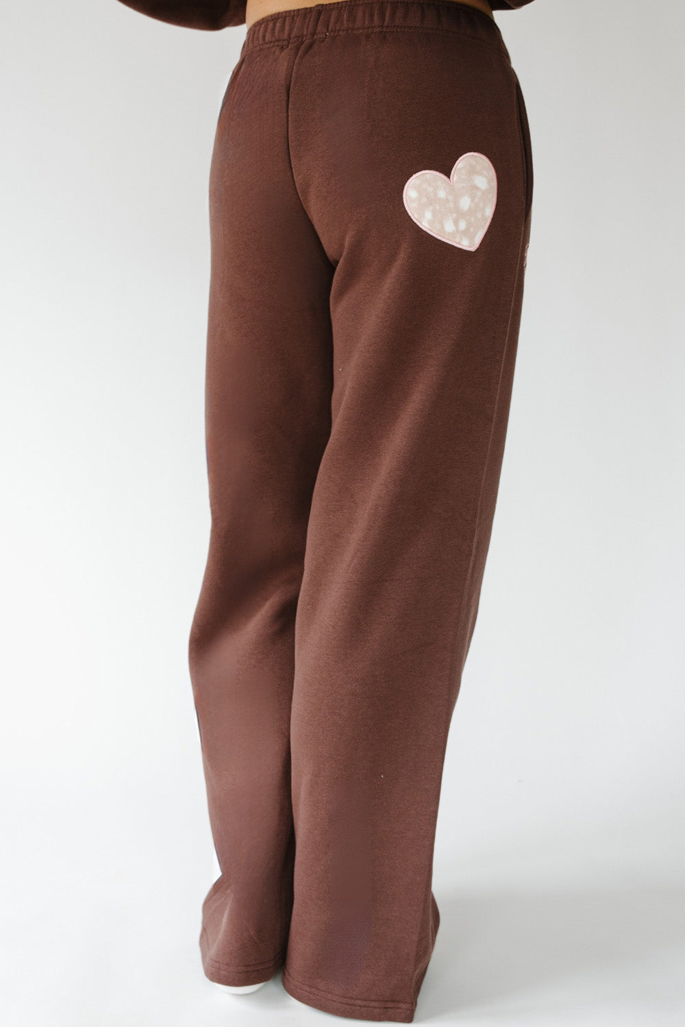 Back of the brown Fawn Love Sweatpants with fawn print heart pocket patch. The Happy Camp3r