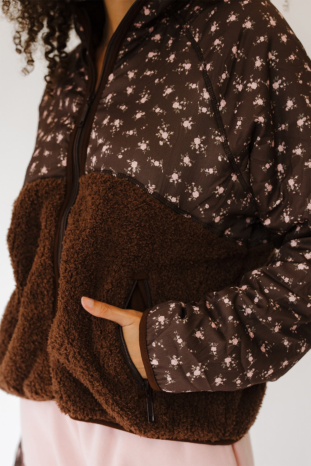 Close up of the Cocoa Blush Macie Sherpa with hand in pocket. The Happy Camp3r