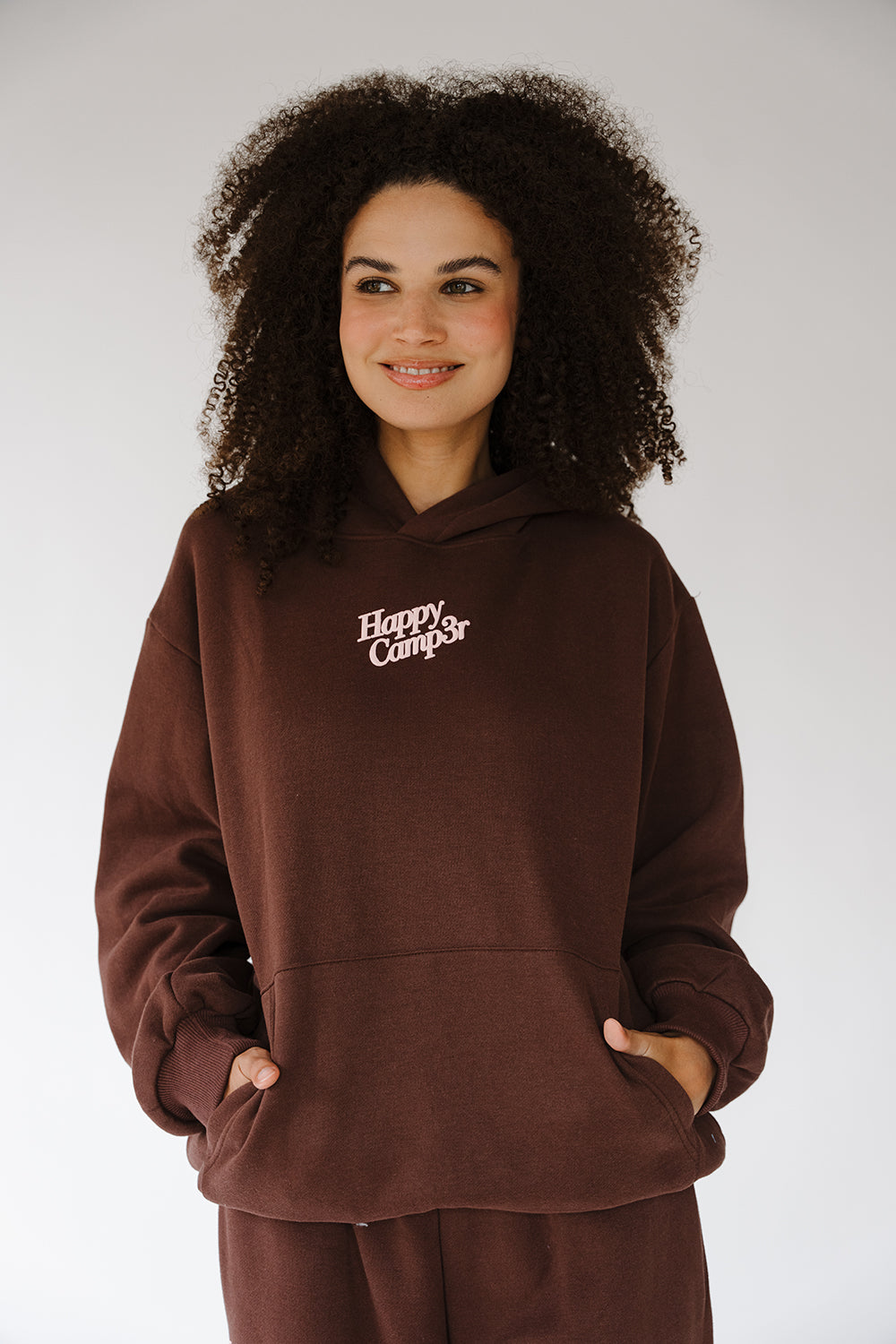 Puff Series Hoodie in espresso brown with cream Happy Camp3r chest logo, front view. The Happy Camp3r