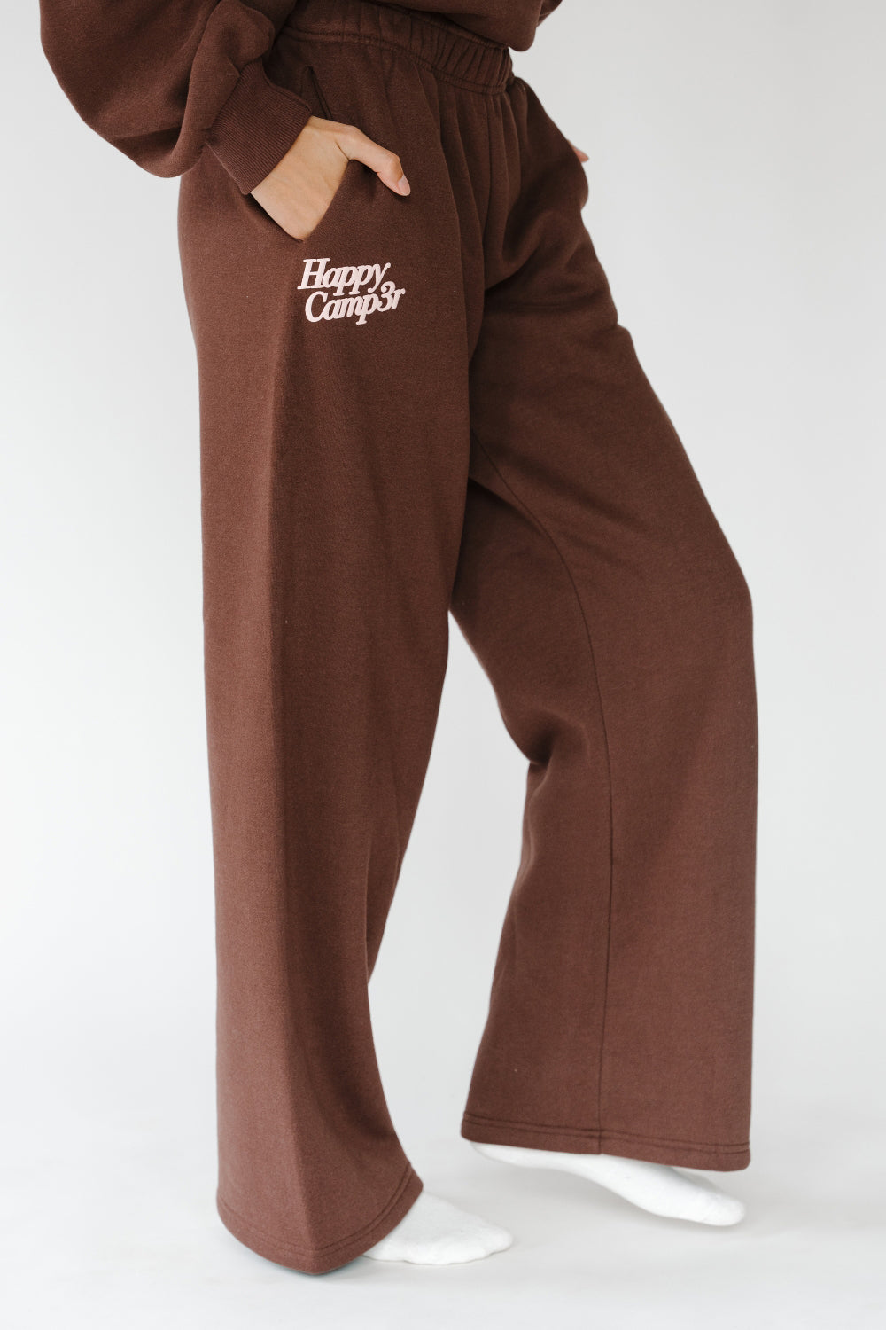 Puff Series Sweatpants in espresso brown with cream Happy Camp3r logo, front view. The Happy Camp3r