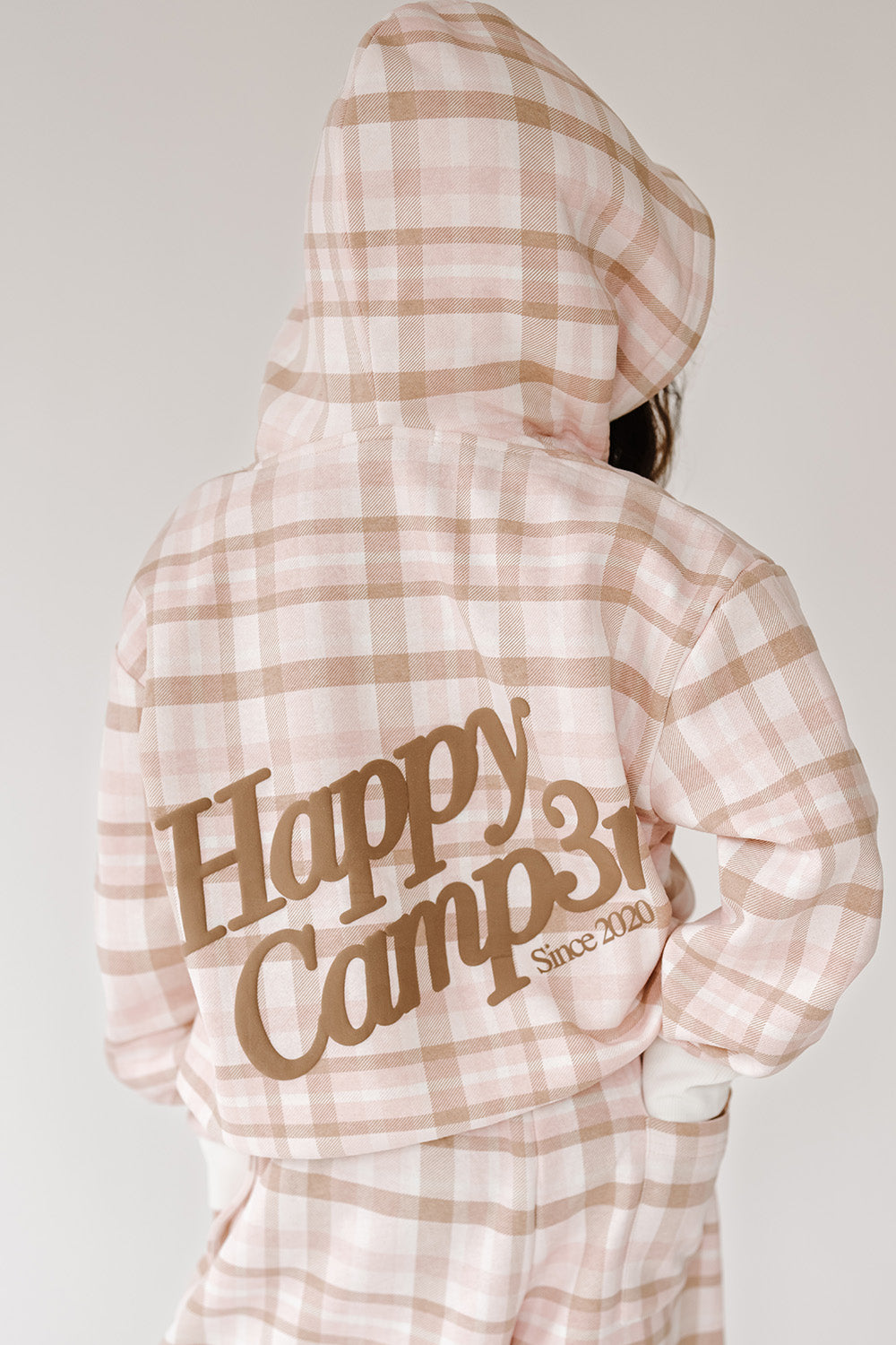 Back of the Pretty In Plaid Youth Hoodie with large tan Happy Camp3r logo. The Happy Camp3r