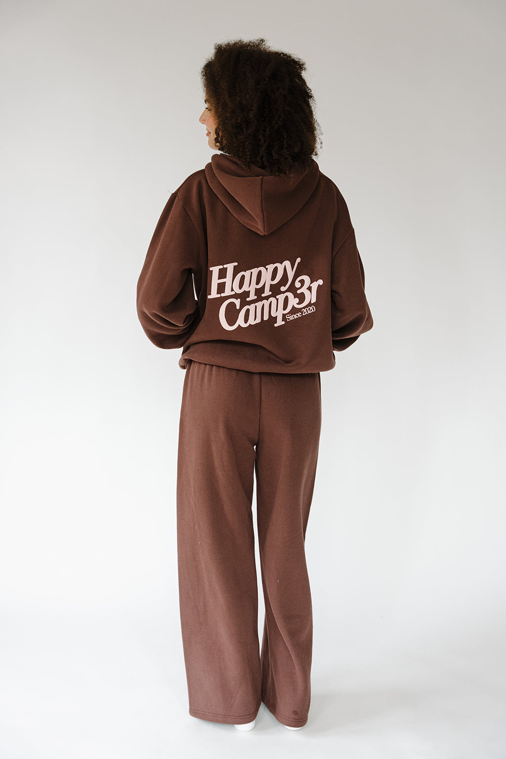Back of the espresso Puff Series Hoodie with large cream Happy Camp3r logo. The Happy Camp3r
