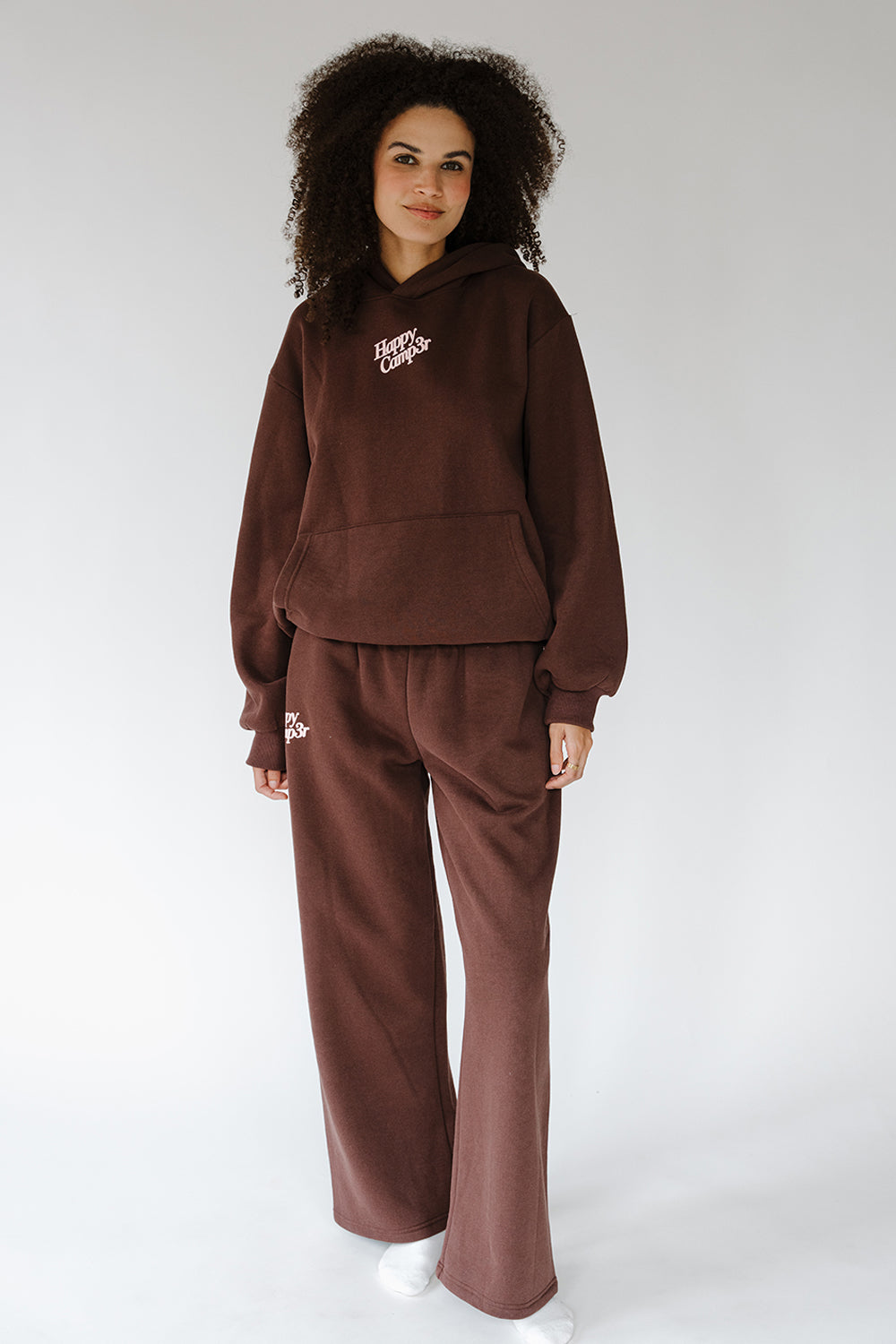 Model in the espresso Puff Series Sweatpants and hoodie, full length. The Happy Camp3r